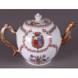 An 18th century porcelain teapot with family coat of arms.