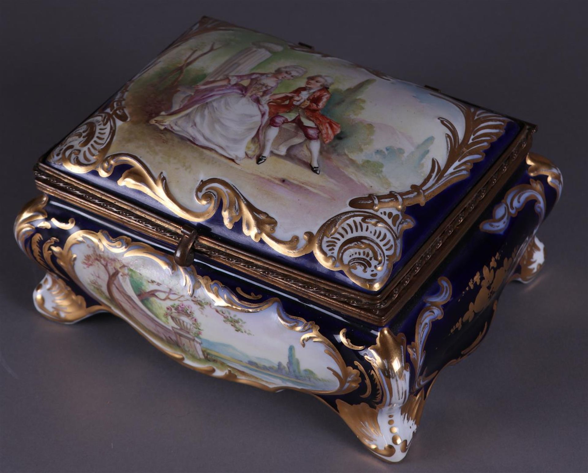 A porcelain lidded box with a romantic scene. France, ca. 1900