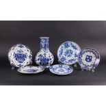 A lot consisting of Delft Blue plates and a ditto vase. All marked De Porceleyne Fles.