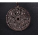 A silver amulet decorated with dragons and signs on the back. China, 19/20th century.