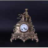 A bronze Louis Phillippe mantel clock with young man at a tree stump.