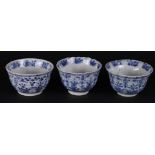 Three ribbed porcelain bowls with floral decor, the inside also with floral decor.
