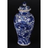 A porcelain baluster-shaped lidded vase with a floral decor, and with large peonies. China, Kanxi.