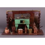 A tin miniature kitchen with accessories including red copper jugs and pots.