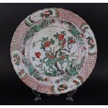 A porcelain Famille Verte dish with grid edge on the outside with four flower beds,