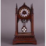 A wooden, neo-Gothic mantel clock with enamelled numerals, First half 19th century