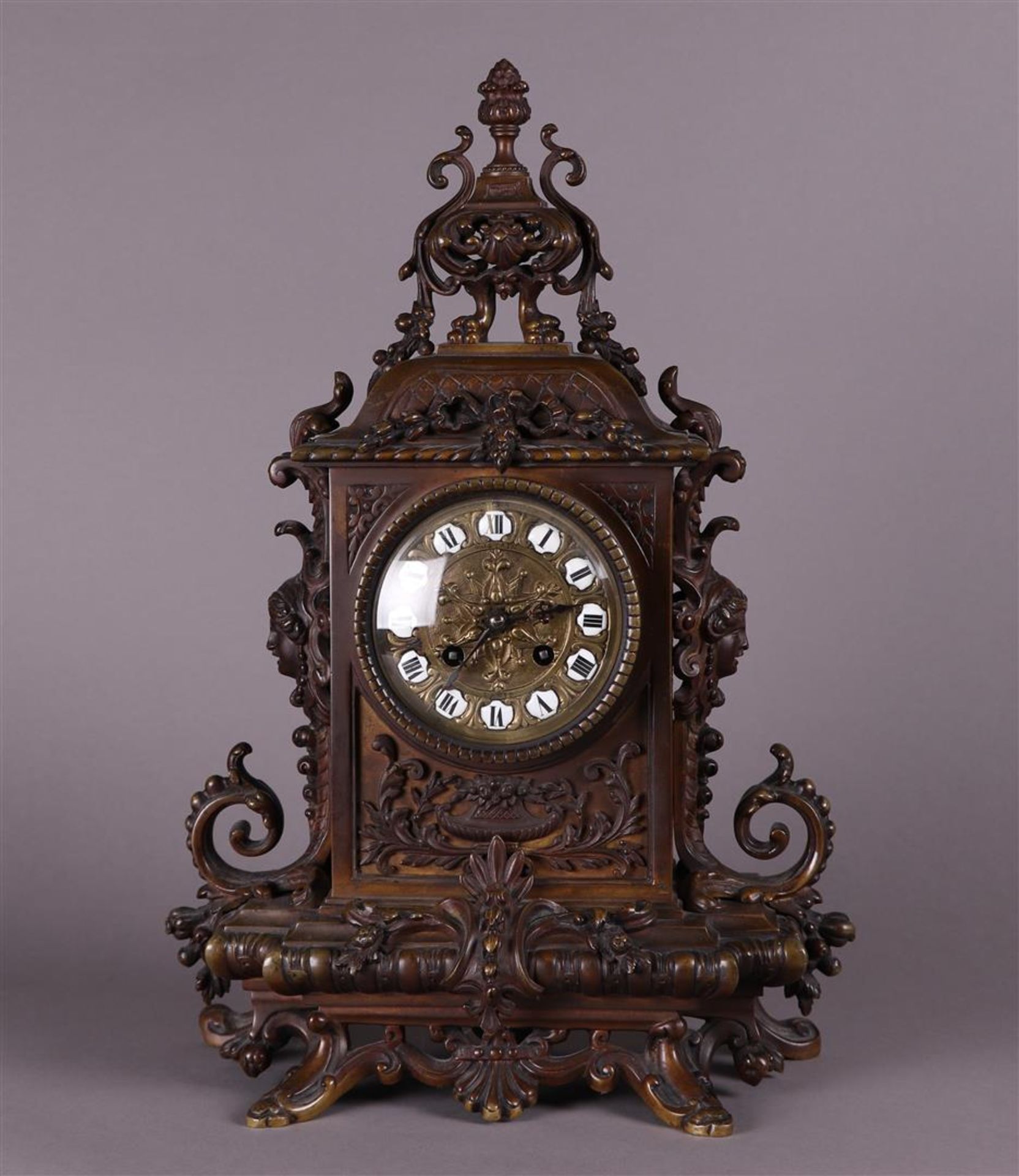 A heavy bronze mantel clock with matching key, ca. 1880.