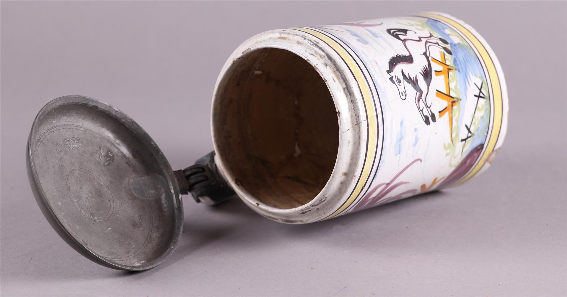 An earthenware beer jug with a polychrome decor of a rearing horse, with a pewter lid. - Image 4 of 5