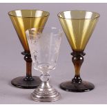 Two colored white wine glasses and engraved glass on silver foot. 19th century.