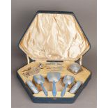 An Art Deco dressing table set in silver and enamel. In original leather box.