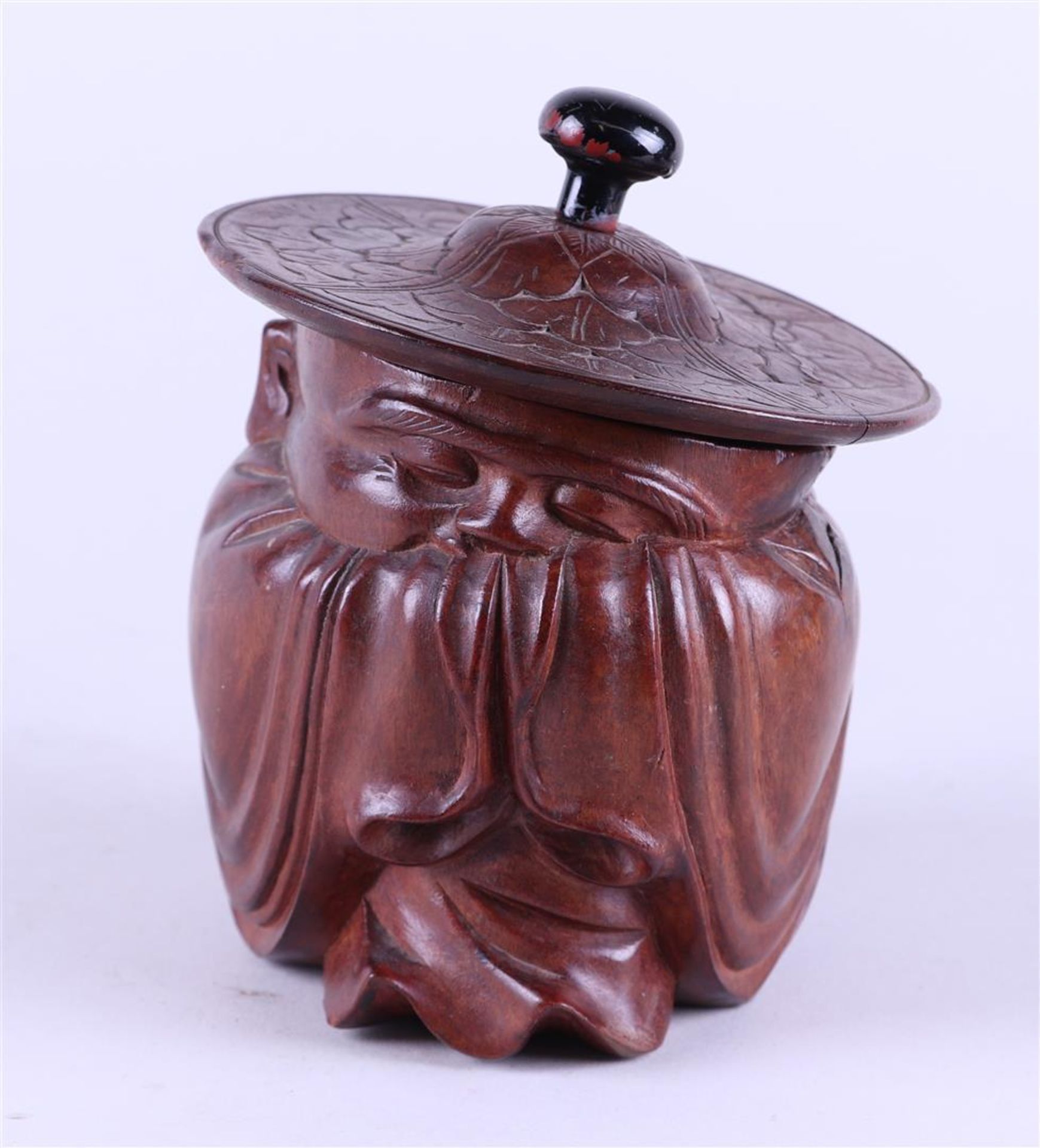 A wooden tobacco jar in the shape of a sage. China, circa 1900.
