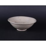 A gray Celadon bowl with ribbed center relief decoration. China, Early Ming period.