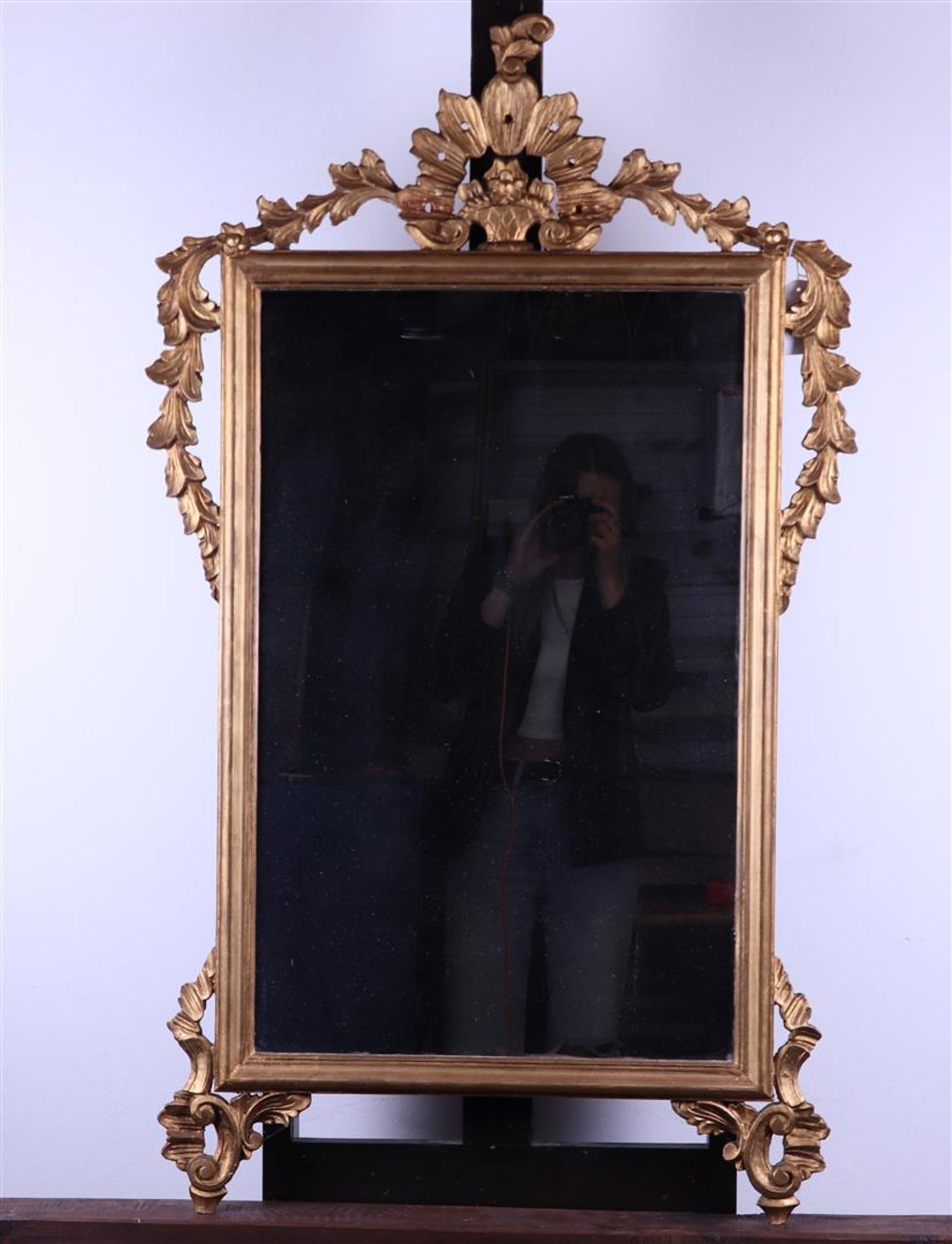 A gilded Louis Seize carved wood and gesso mirror, 18th century. Replace glass. Damage to the top.