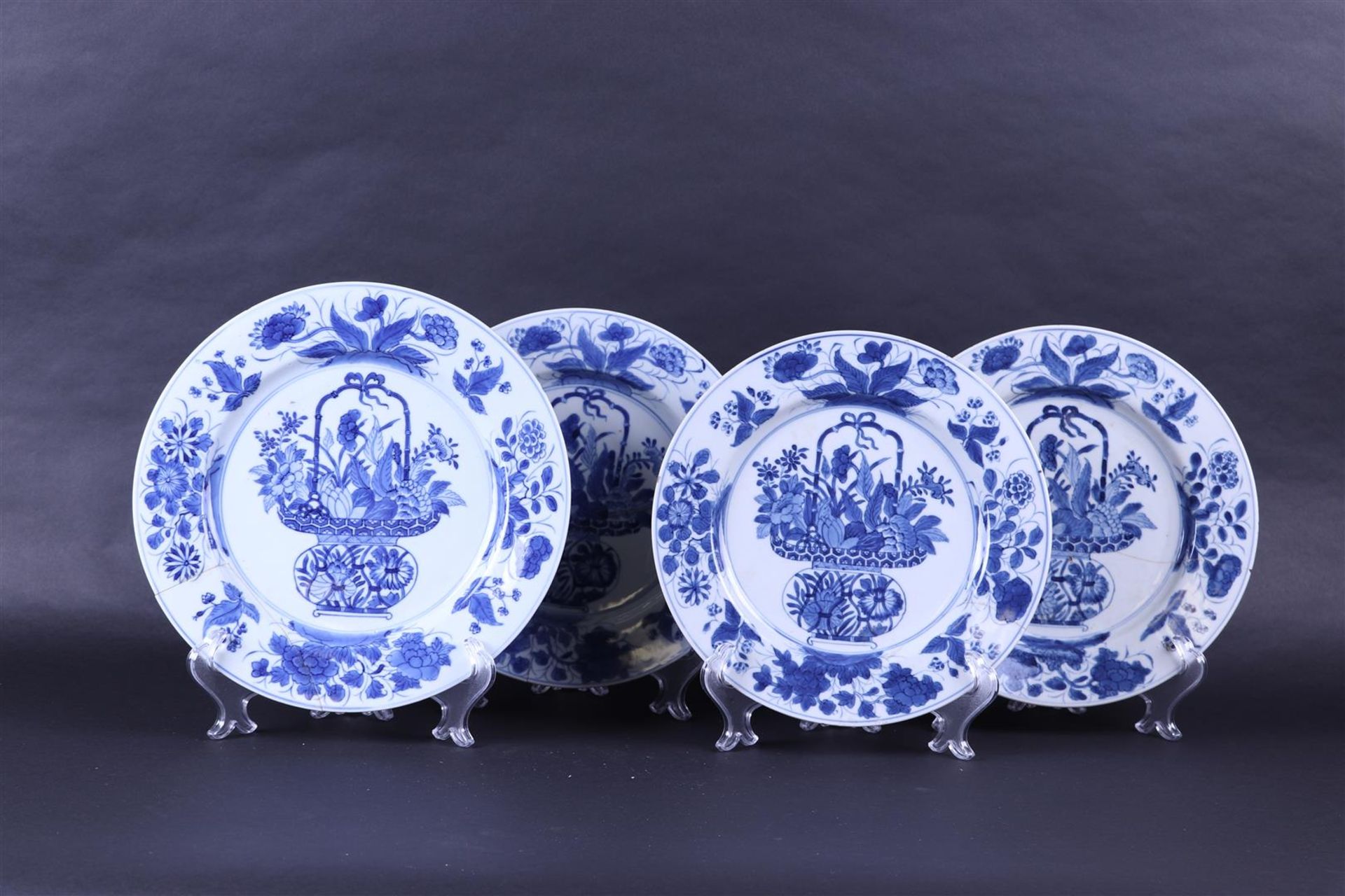 A lot of four porcelain plates decorated with a floral basket. China, Kanxi.