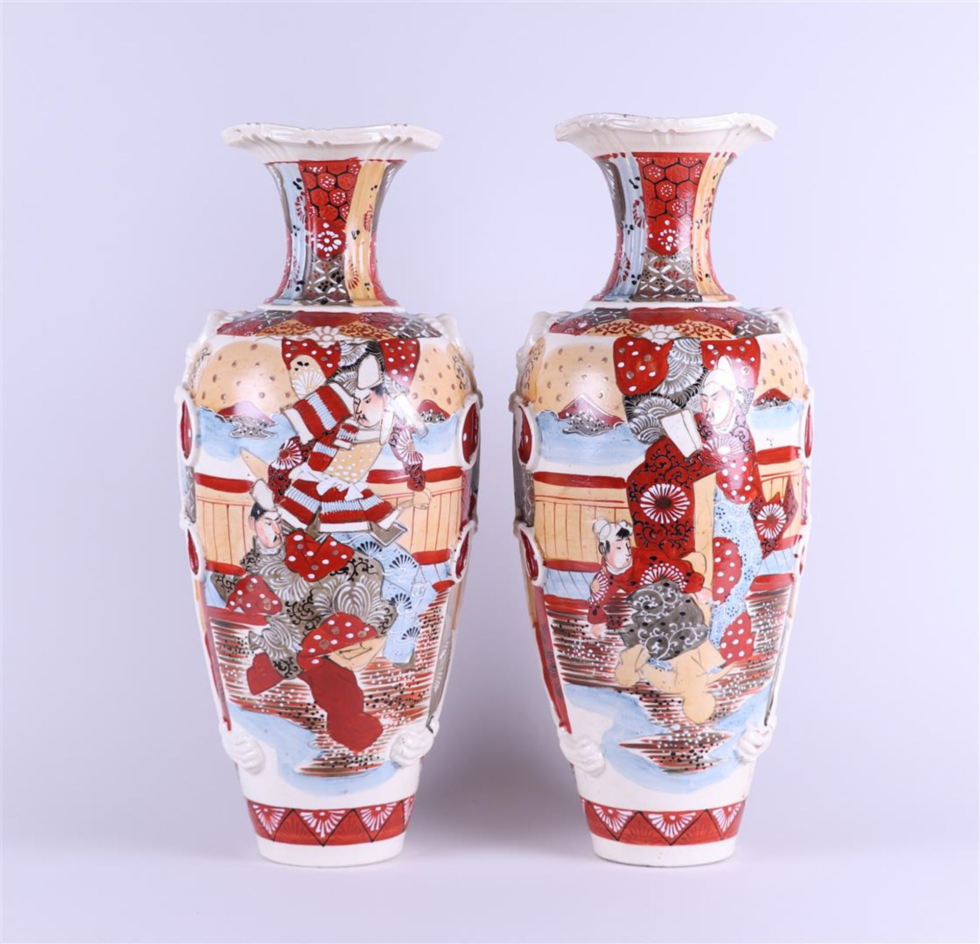 A set of two Satsuma earthenware vases decorated with various figures. Japan, circa 1900.