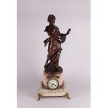 A large marble mantel clock with a zamac sculpture of a lady with a Mandola on top,