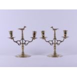 A set of brass two-light candlesticks with a bird in the centre. Holland, 19th century.