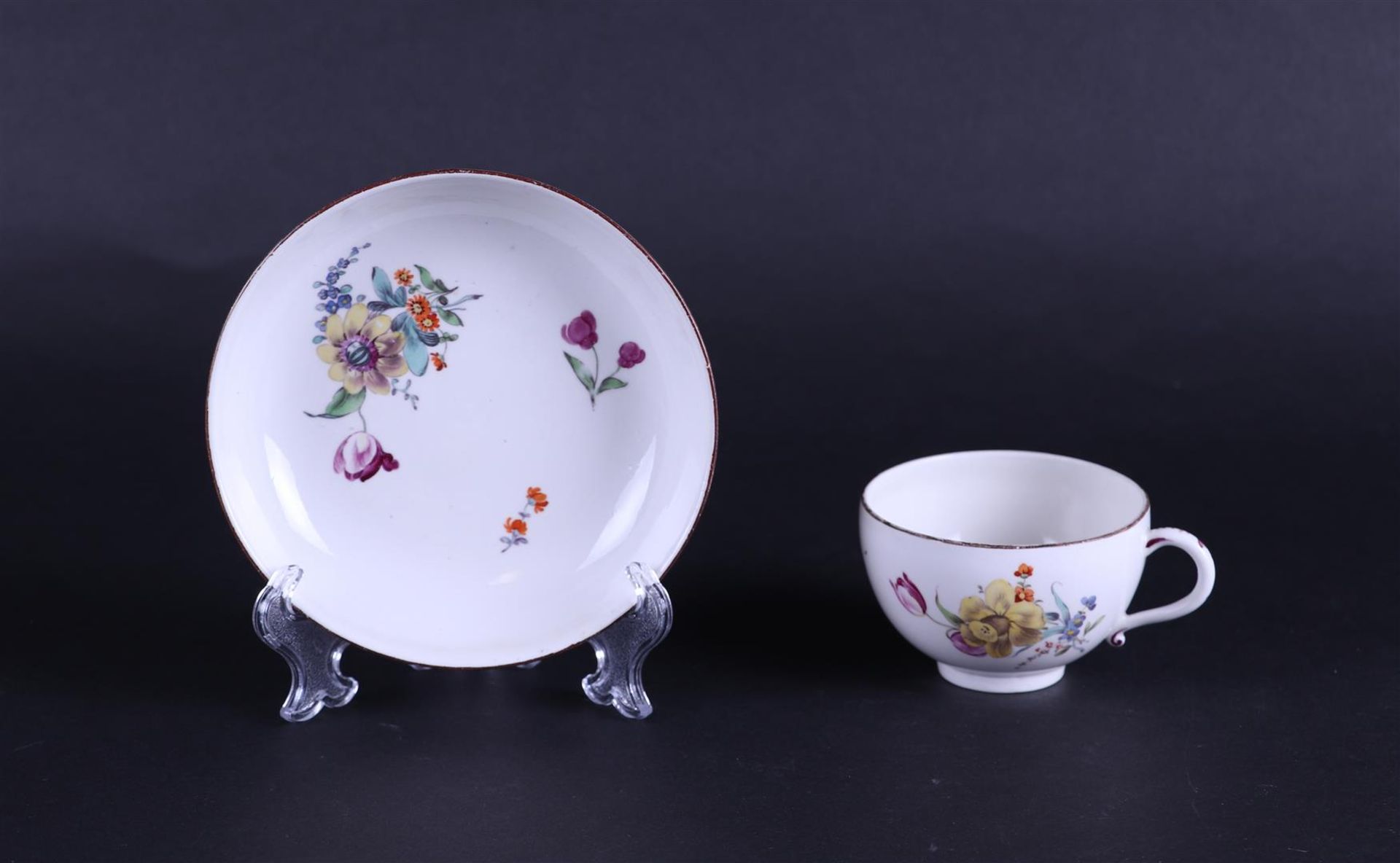 A porcelain cup and saucer with rich, polychrome floral decoration. German, Höchst 18th century. - Image 2 of 3