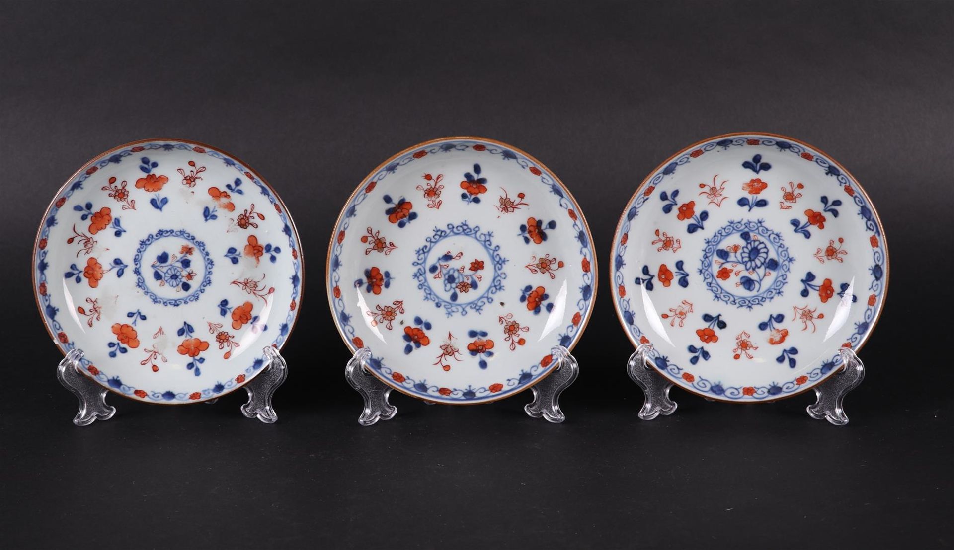 Three porcelain Imari plates with floral decoration. China, Qianlong.