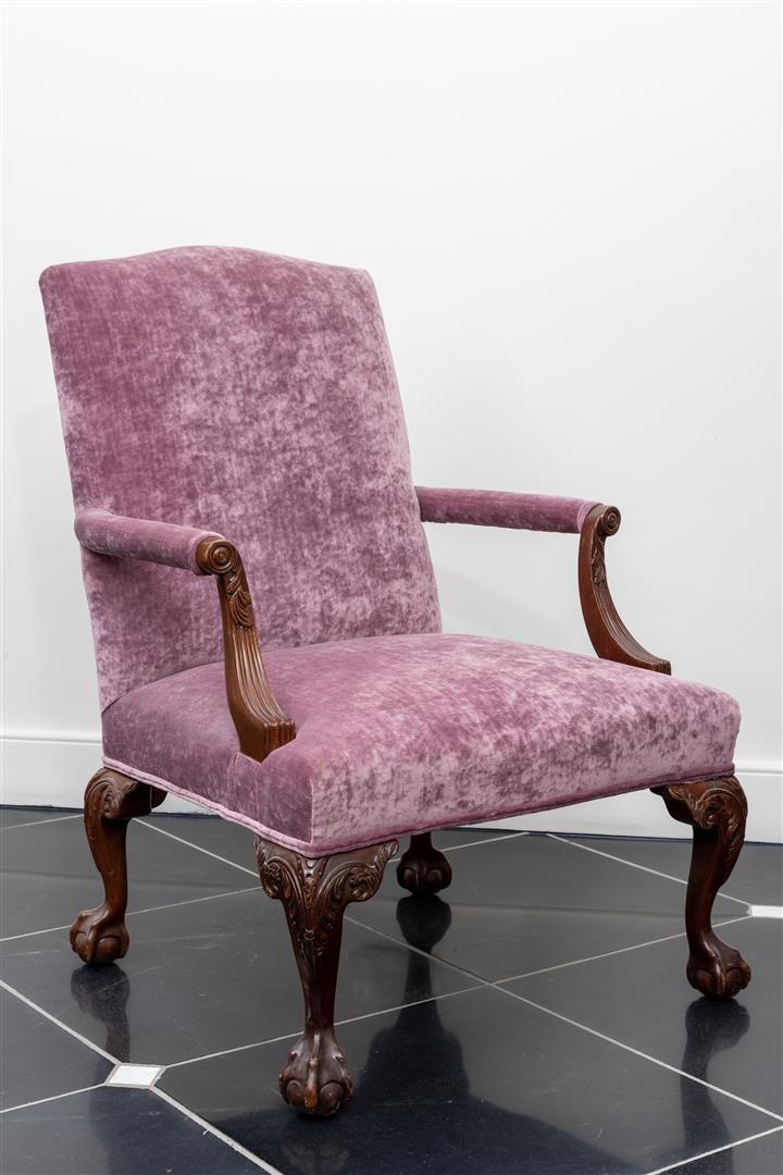 An armchair upholstered in purple fabric, after an 18th century example.