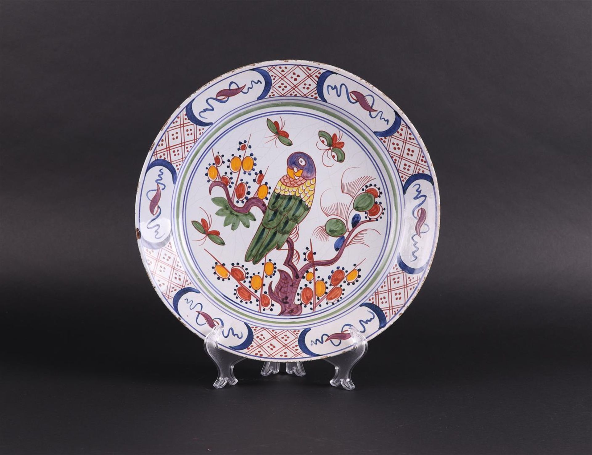 An 18th-century Dutch polychrome dish, with a parakeet decor.