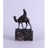 A bronze depicting an Arab on a dromedary, signed in the foot: "L. Carvin".