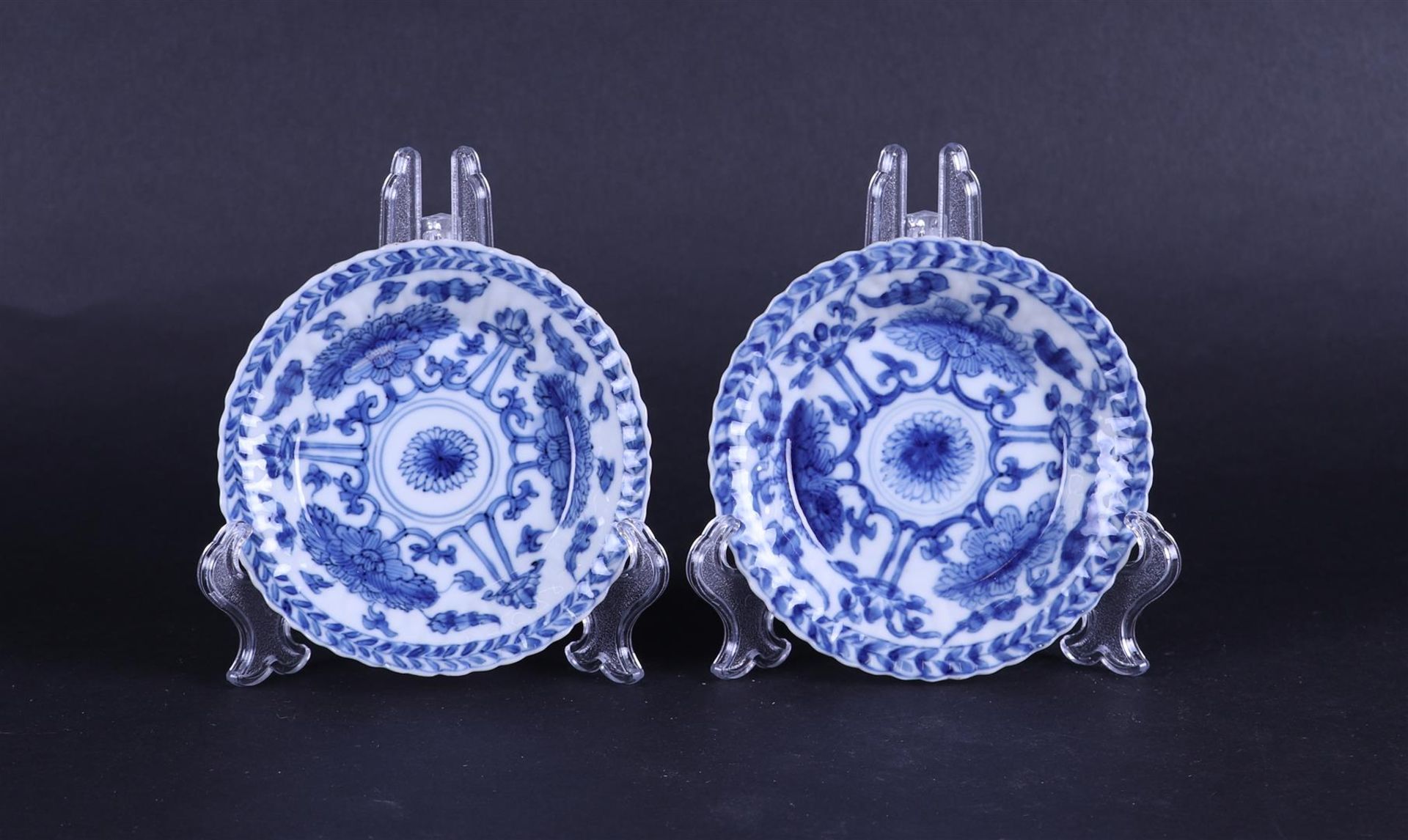 Two ribbed dishes with lotus flower decor, marked on the back with a seal. China, Kanxi.