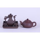 A lot consisting of a Yixing teapot, a ditto pot and four cups on a tray. China, 20th century.