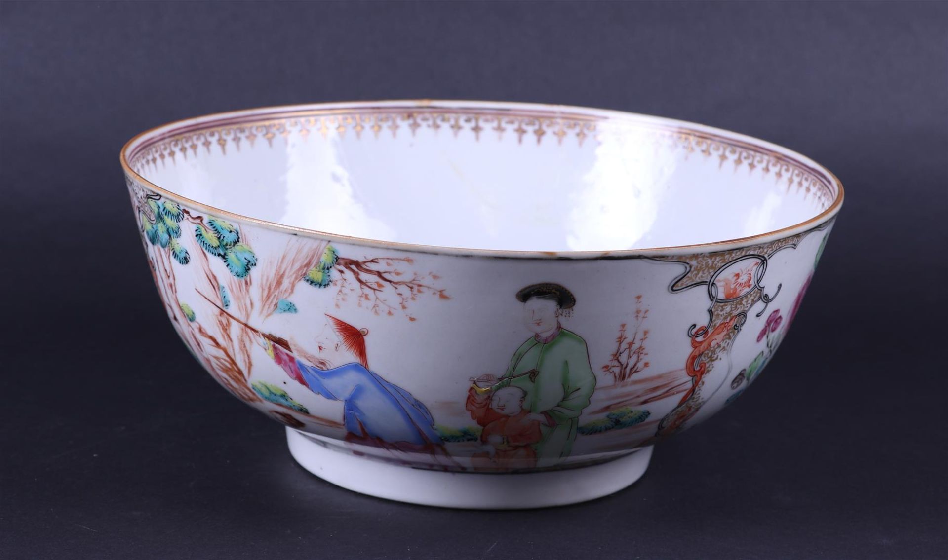 A large porcelain Chine de comande bowl decorated with various figures. China, 18th century.