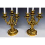 A pair of French bronze three-armed candlesticks, 19th century.