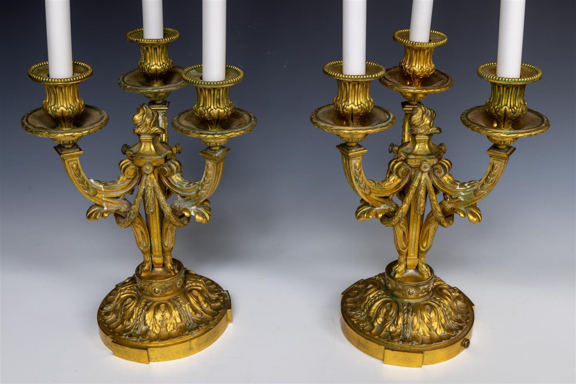 A pair of French bronze three-armed candlesticks, 19th century.