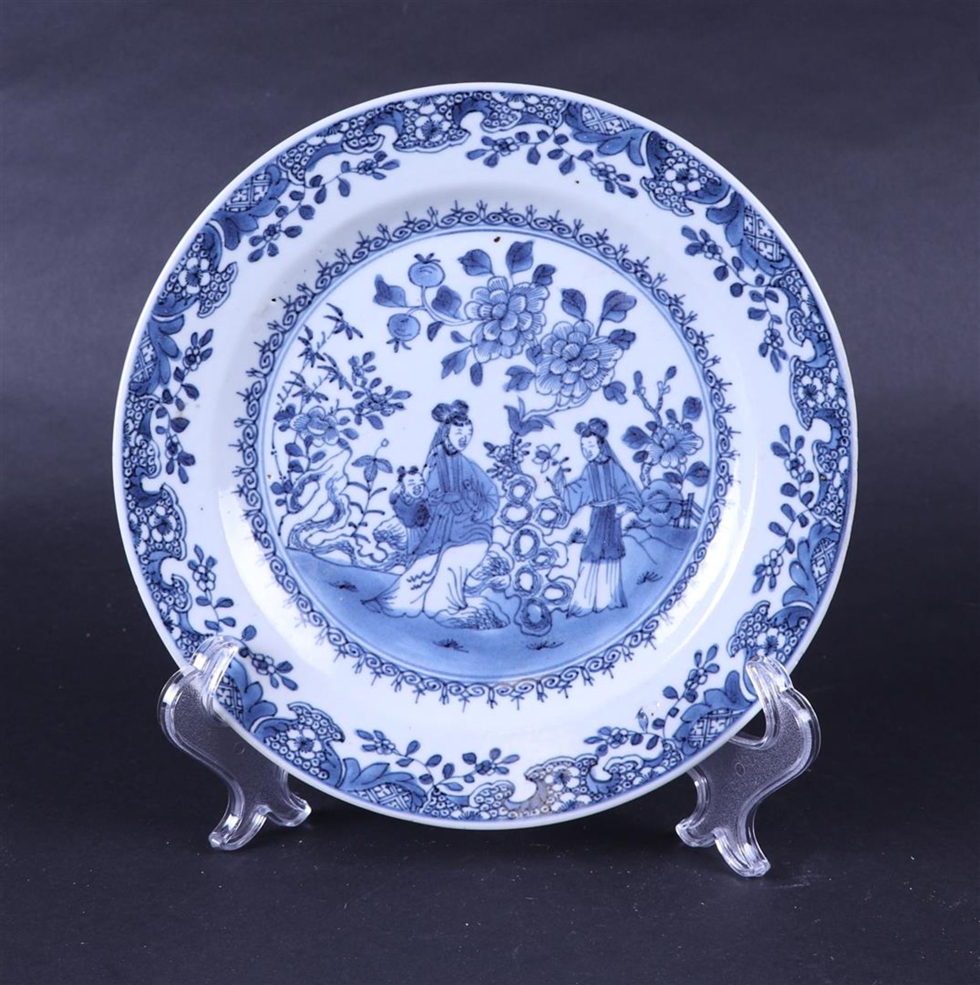 A porcelain plate with court ladies  in a garden. China, 18th century.