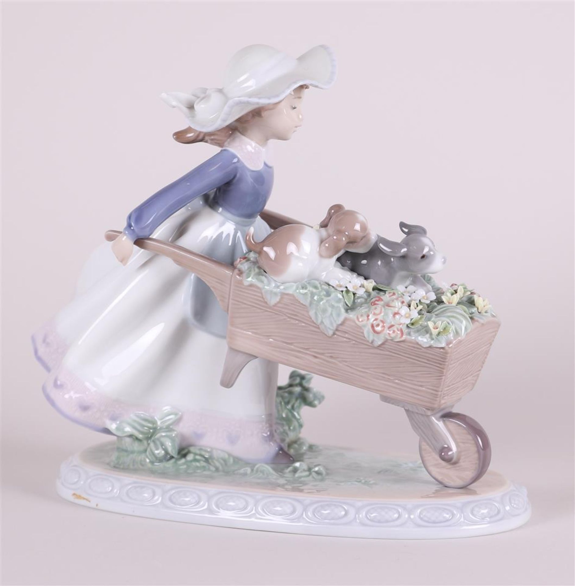 A porcelain group of a girl with a wheelbarrow. Ladro, Spain. - Image 4 of 4