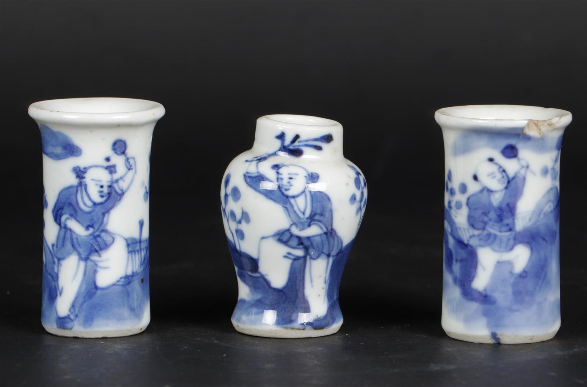 A porcelain miniature  cupboard set vases  decorated with fools. China, 19th century.