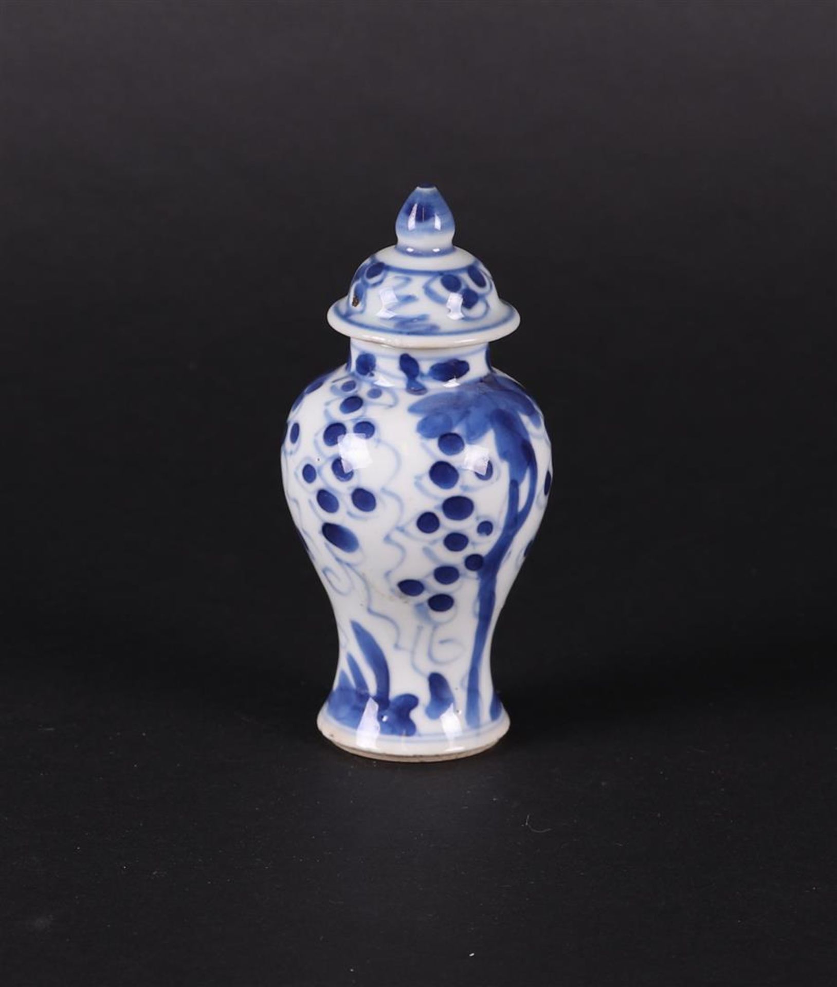 A porcelain lidded vase with floral decoration  and grapes in between. China, Qianlong.