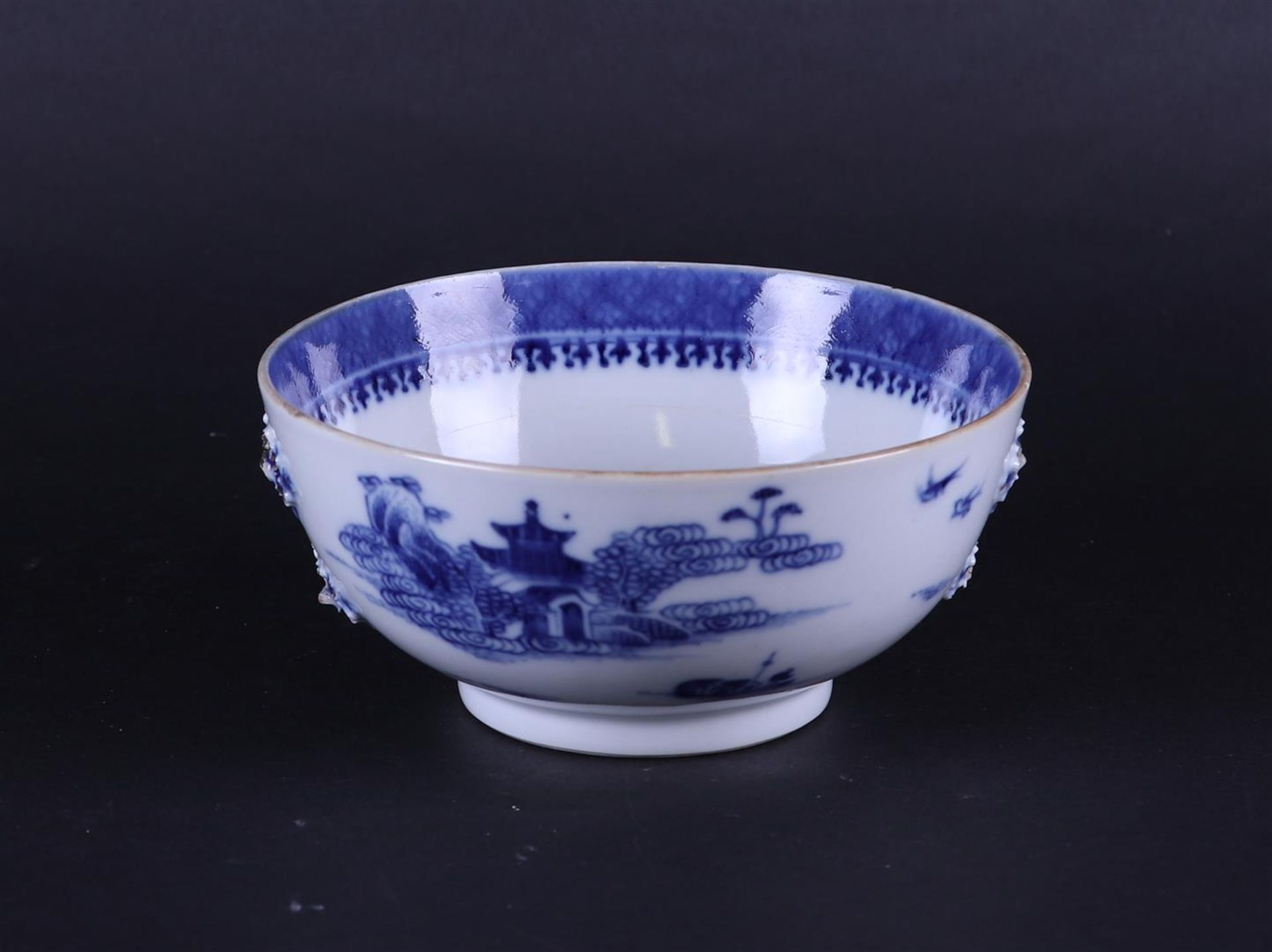 A porcelain bowl with river landscape decor on the outside and embossed flowers on the outside.  - Image 3 of 5