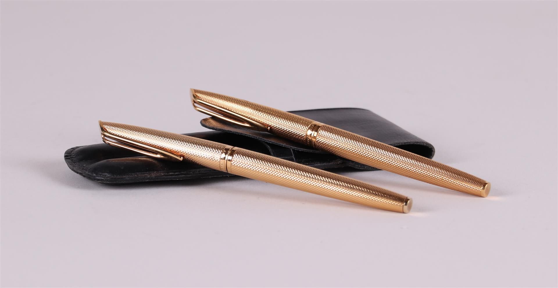 A gold-plated pen set in leather case Waterman. Marked in the edge.