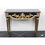 An Empire style console table with a marble top.