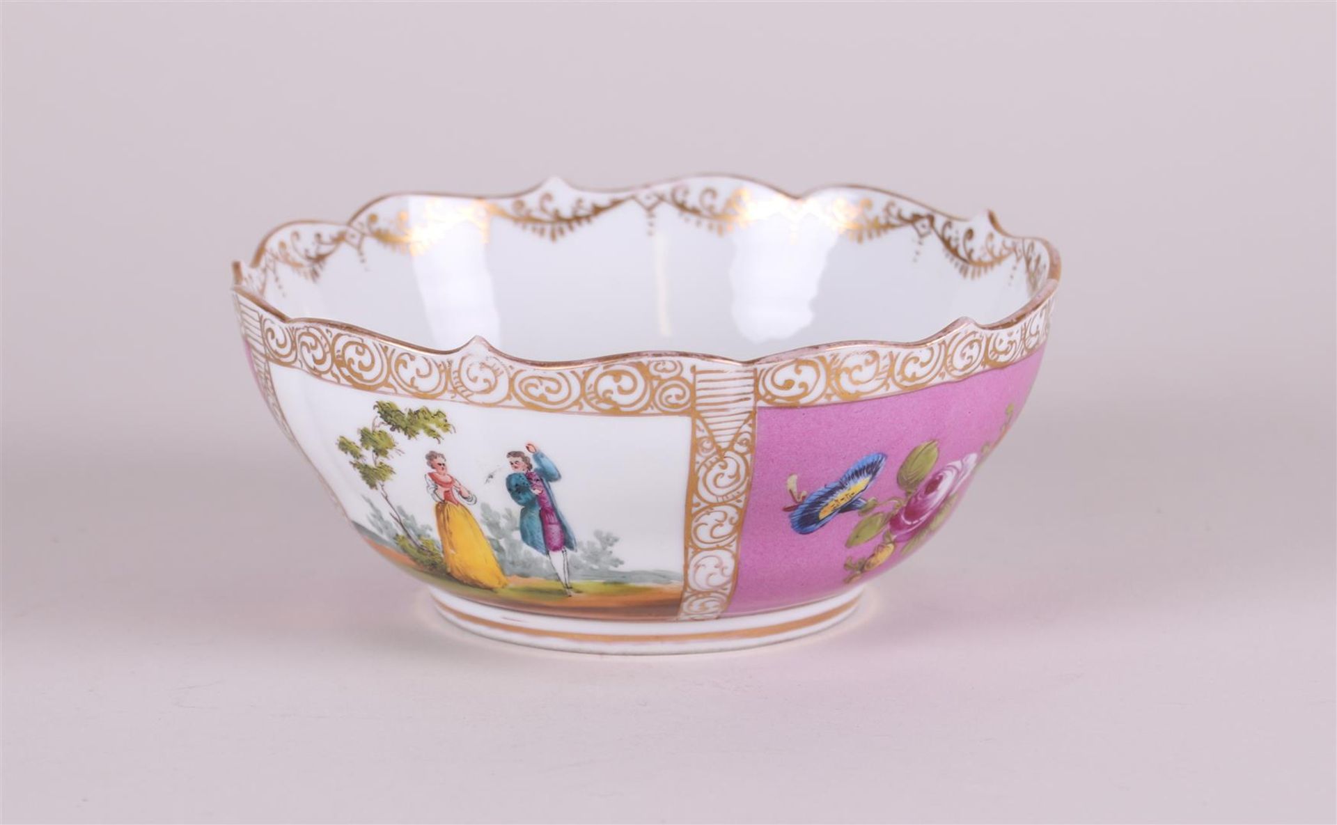 A porcelain bowl decorated with various figures, marked Dresden. Circa 1900.