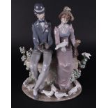 A porcelain group of a young couple on a bench, marked Lladro. Spain, late 20th century.
