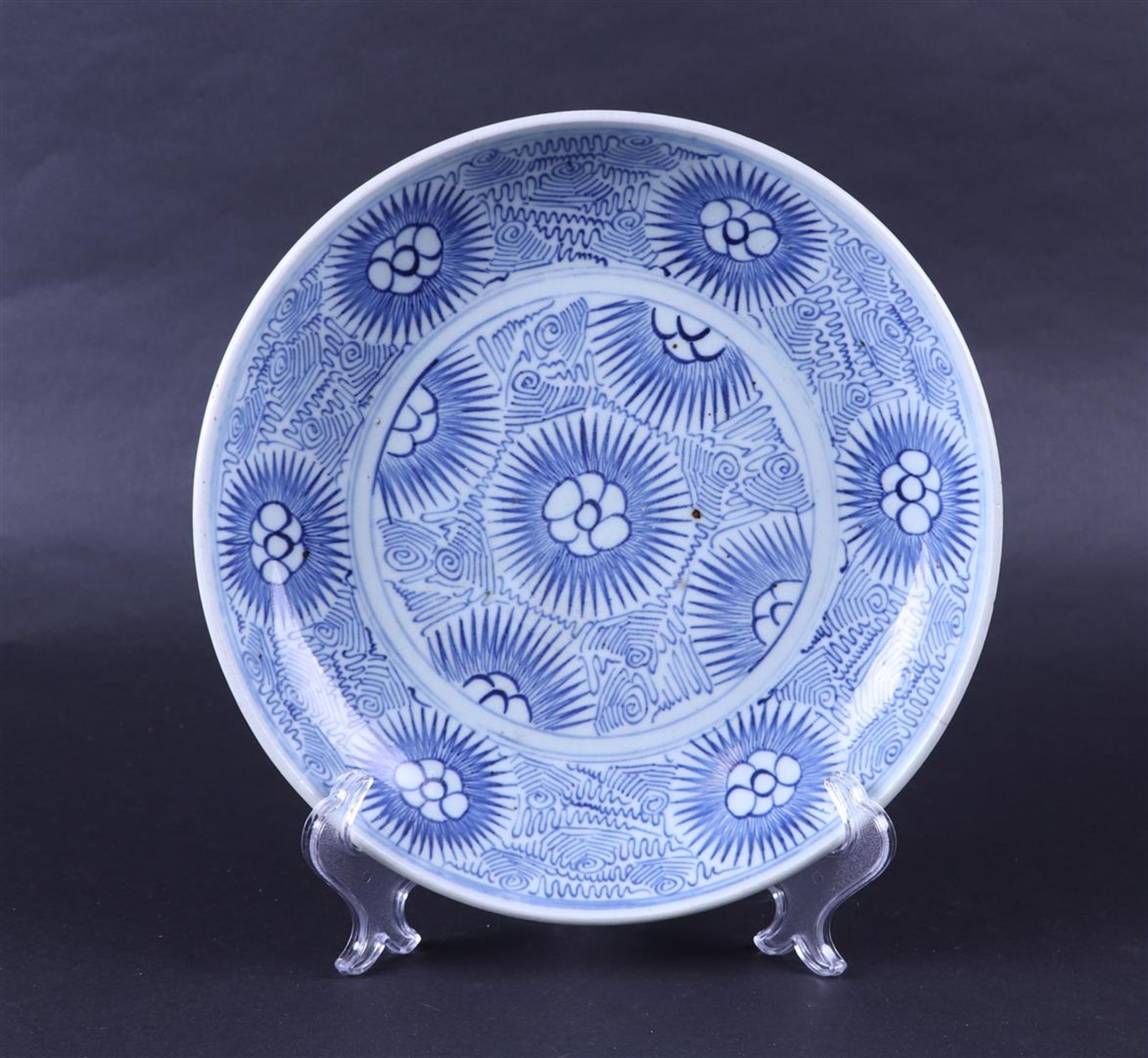 A porcelain dish from the Vung Tau cargo, decorated with stylized flowers. China, circa 1800.