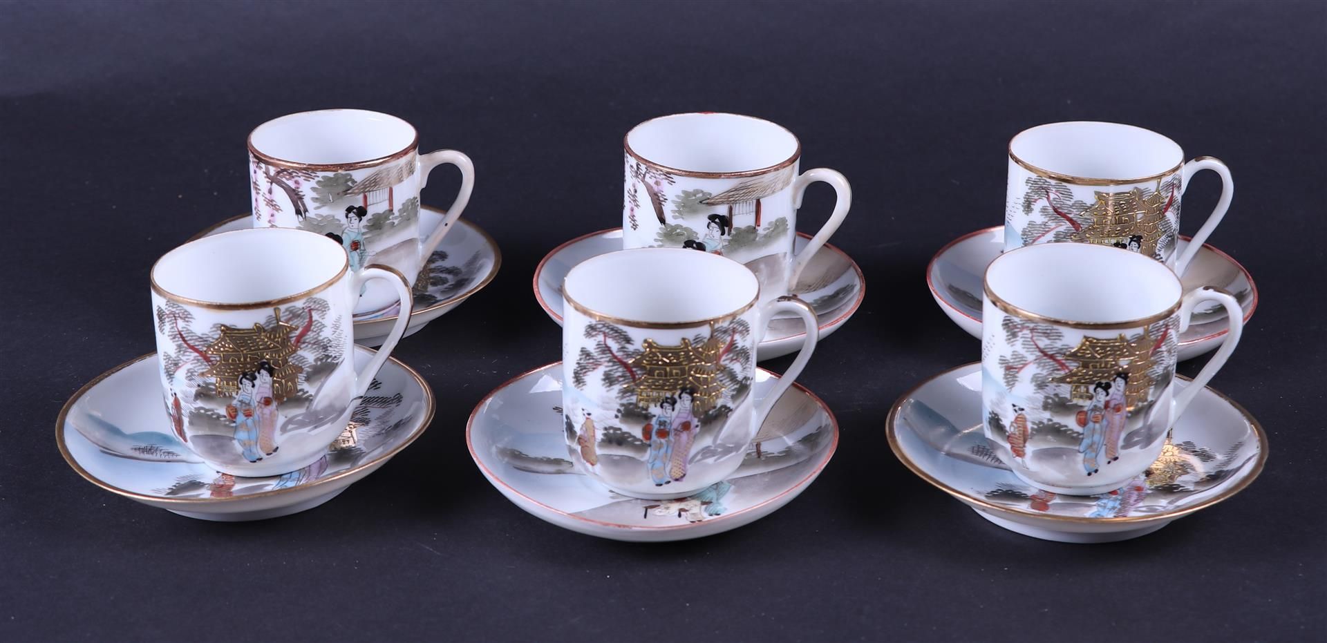 A set of six cups and saucers decorated with various figures and heightened with gold painting