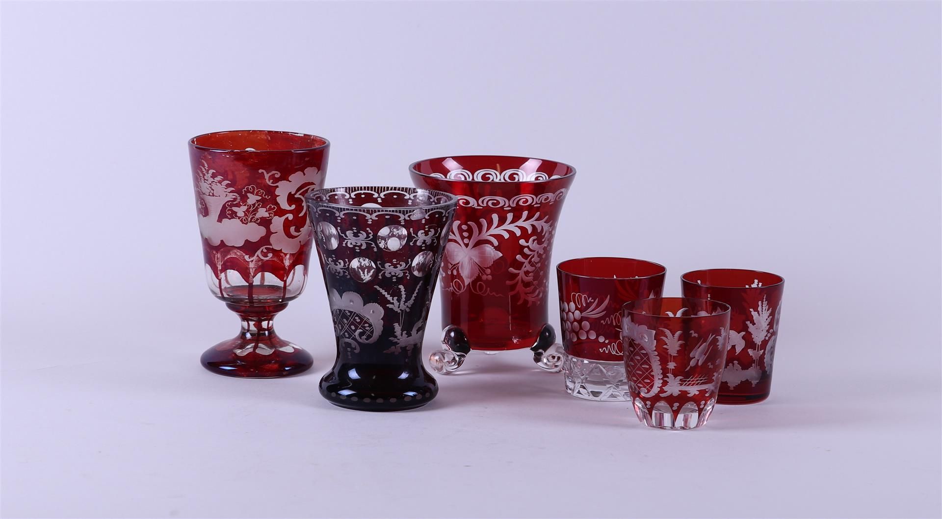 A lot containing red Bohemian glass including three vases and three glasses.