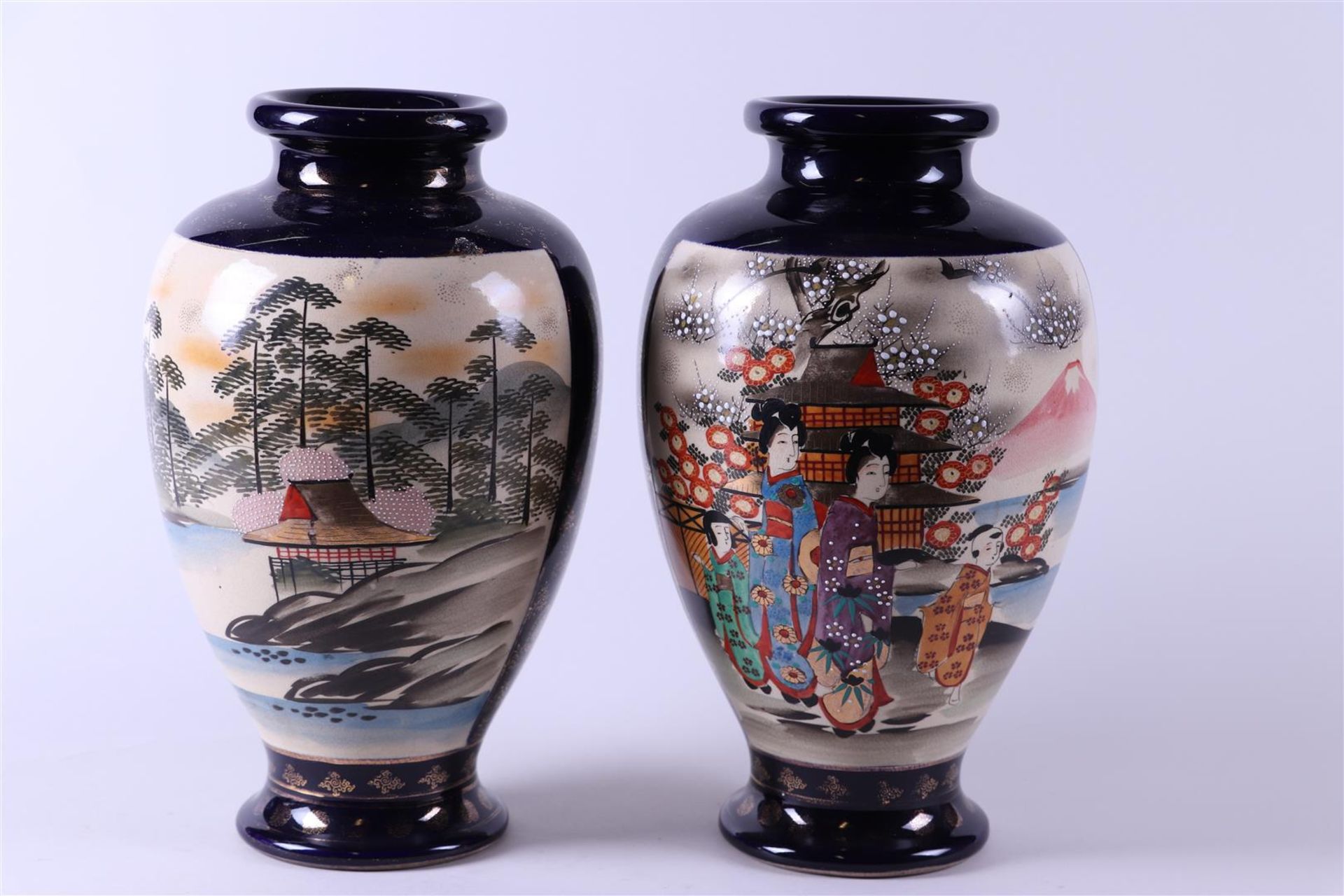 A set of two Satsuma pottery vases decorated with various figures. Japan, early 20th century.