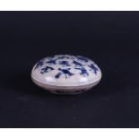 A soft paste lidded box decorated with fools, marked underneath.