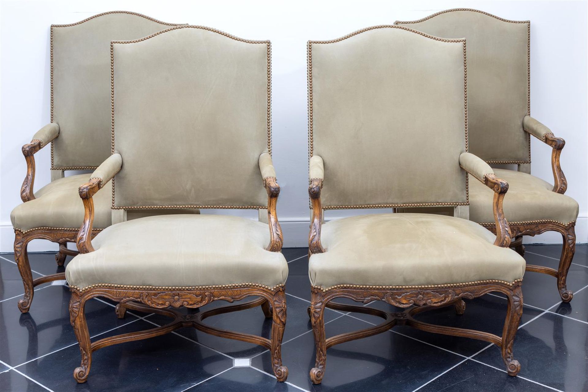 A set of four armchairs upholstered in green fabric, Louis XV style, 20th century.