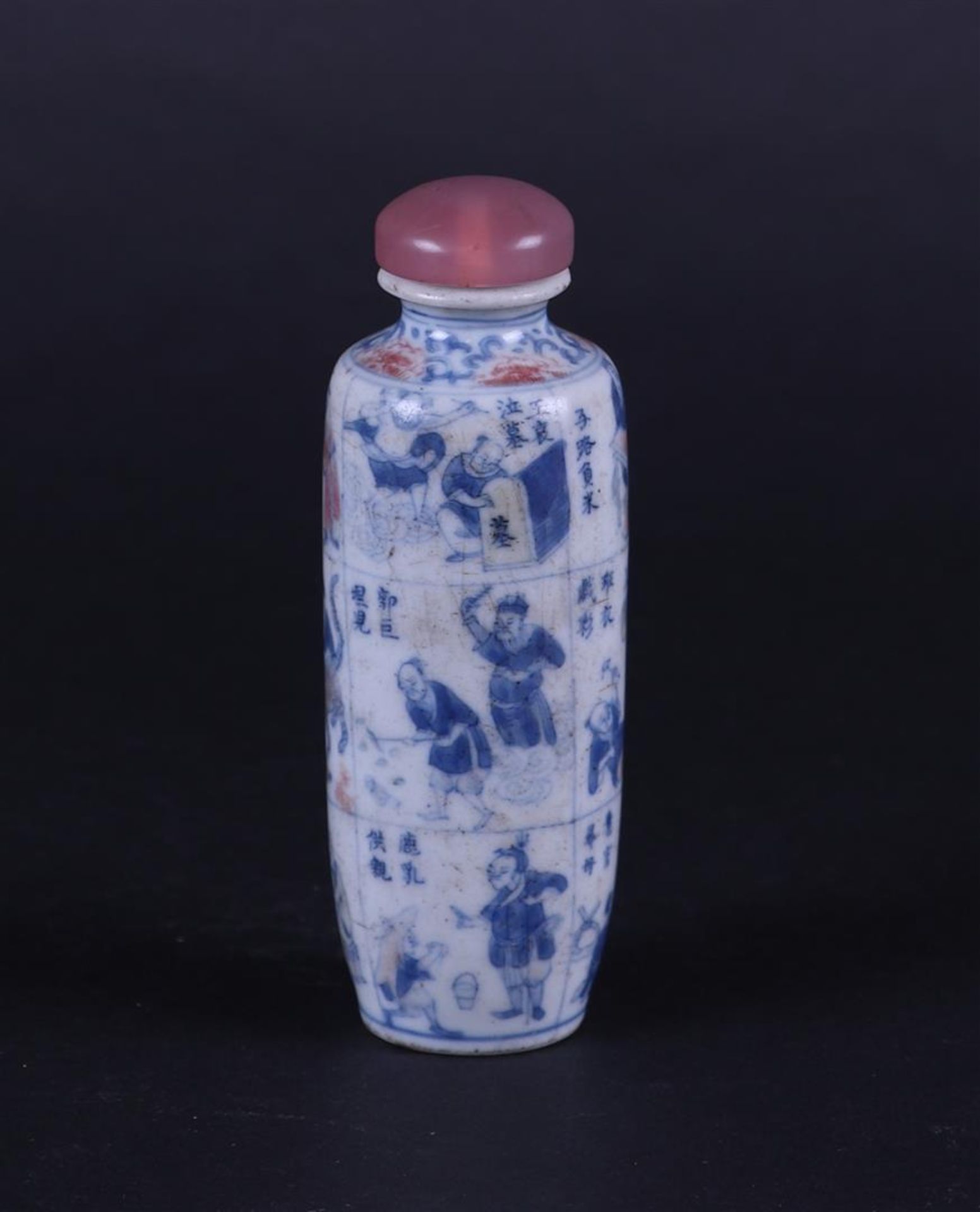 A porcelain snuff bottle with a narrative decor of figures and Chinese text in each compartment. 