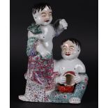 A porcelain famile rose group of two fools, marked on the bottom. China, Republic period.