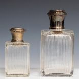 A lot consisting of (2) glass dressing table bottles with silver-plated stoppers.