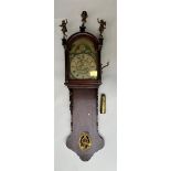 A Dutch Frisian hanging clock with wooden Fama figures, atlas, moon face, alarm clock.